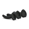 Set of three black non representational silicone dildos. Thin dildos with slightly tapered rounded tips and no pronounced heads. Three progressively sized pieces. Each has a consistent diameter all along the shaft, which has a subtle swirl texture. Slight upward curve. Heart shaped suction cup bases. Additional images show alternate angles.