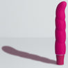 Pink slim vibrator with gentle spiral texture, curved for g spot play. Single button on bottom. Additional images show alternate angles.