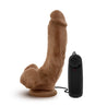 Vibrating realistic cock with suction cup. Mocha skin tone with pronounced head, veins along the slightly downwardly curved shaft, and plush balls. Wired remote with twist dial to adjust intensity. Additional images show alternate angles.