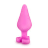 Pink butt plug with a tapered tip that gradually increases in size, a thin neck, and a heart shaped base. The words "Ride Me" are engraved on the base to create the look of a candy conversation heart. Additional images show alternate angles.