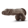 Chocolate skin tone ultra realistic dildo. Featuring a tapered realistic head for easy insertion, skin folds and veins along the straight but flexible shaft, and round realistic balls. Suction cup base. Additional images show alternate angles.