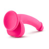 Hot pink dildo with realistic features. Featuring a realistic head with a pronounced lip, slim, smooth downwardly curved shaft with a slight ribbed texture on the top side just below the head. Smooth balls. Suction cup base. Additional images show alternate angles.