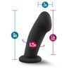 Black non-representational dildo. With a pronounced head that features a dimple to represent a urethral opening, a smooth thick shaft with and upward curve and a suction cup base.  Additional images show alternate angles.