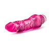 Translucent pink vibrating dildo has a realistic shape, with a defined but tapered head and veins along the shaft. Twist dial on bottom to adjust intensity. Additional images show alternate angles.