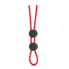 Red, lasso style, thin, rounded ring with two button slides for easy adjustment. The two buttons create two loops that go around the shaft and balls in a number of different configurations. Loose ends can be moved around for comfort. Additional images show alternate angles.