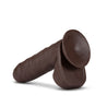 Chocolate skin tone realistic uncut dildo. Featuring a smooth rounded head covered partially by foreskin, veins along a straight but flexible shaft, and realistic balls. Suction cup base. Foreskin and rest of dildo are one piece, foreskin doesn't move or pull back. Additional images show alternate angles.