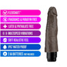 This chocolate skin tone vibrating dildo has an ultra realistic shape that offers significant girth, with a subtly defined head and veins along the shaft. Twist dial on bottom to adjust intensity. Additional images show alternate angles.