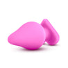 Pink butt plug with a tapered tip that gradually increases in size, a thin neck, and a heart shaped base. The words "Ride Me" are engraved on the base to create the look of a candy conversation heart. Additional images show alternate angles.