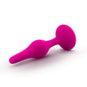 Small pink smooth silicone anal plug. Featuring a gently tapered tip, slight bulbous shape in the slim body, a narrower neck, and a circular flared base for safety.  Additional images show alternate angles.