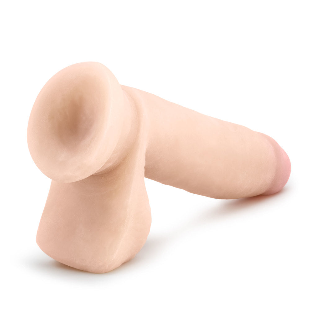Vanilla skin tone ultra realistic dildo with a tapered realistic head for easy insertion and a smooth straight but flexible shaft. Realistic balls. Head is slightly tinted in a pink color for a lifelike look. Suction cup base. Additional images show alternate angles.