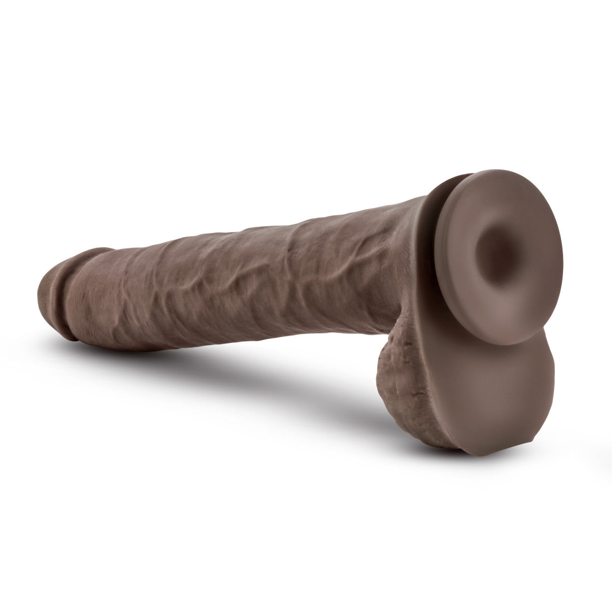 Chocolate skin tone realistic dildo. Featuring a rounded head, veins along the straight but flexible shaft, and realistic balls. Suction cup base. Additional images show alternate angles.